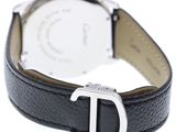 a close up of a watch on a white surface