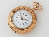 a gold pocket watch with roman numerals on it