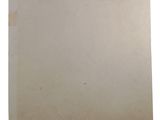 an old piece of paper with a sticker on it