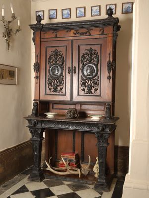 a wooden cabinet in the corner of a room