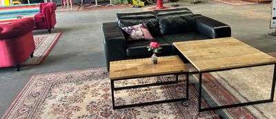 an image of a living room with couches and coffee tables
