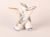 two white vases with blue and yellow designs on them