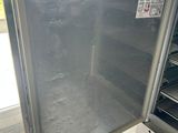 a refrigerator that is open on the outside of a building