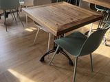 many chairs and tables in a room with wood floors