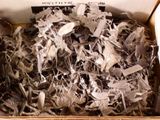 a cardboard box filled with lots of silver pieces