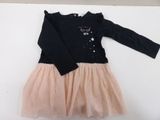a black shirt and a pink tutu skirt on a white surface