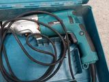 a blue box with a drill and a cord in it