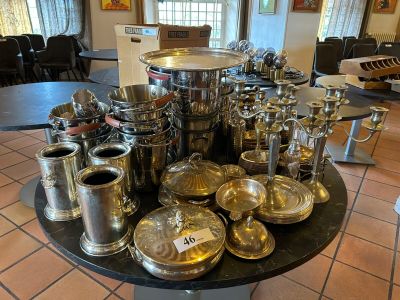 a lot of silver items on a table in a room