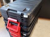 a black case with a red handle on top of it