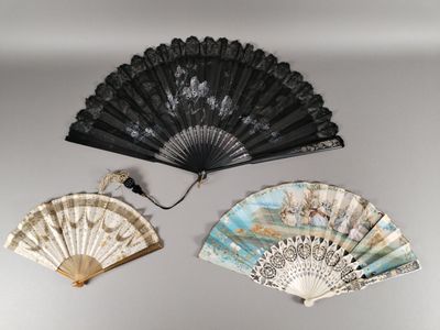 two black and white fans are sitting on a white wall