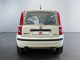 a small white car that is parked in a room