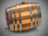 a wooden barrel with metal straps on a gray background