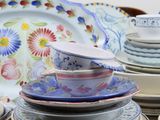 many plates and bowls stacked on top of each other