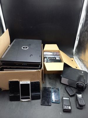 a lot of cell phones and a laptop in a box