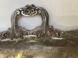 a large silver tray with a handle on it