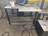 a table with a laptop on it in a room