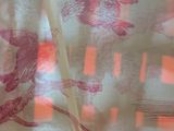 a close up of a curtain with a bird design on it
