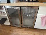 two refrigerators that are on the counter in the kitchen