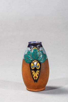un petit vase orné d'un motif, posé sur une table
