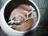 a dirty pot with a broken handle inside of it