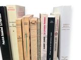 many books that are stacked on top of each other