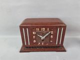 a small wooden clock that is sitting on a table