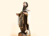 a figurine of a man with a cat on a table