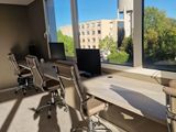 a picture of a home office with a view of the city