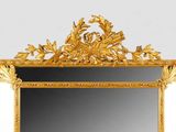 an image of a gold framed mirror on a white wall