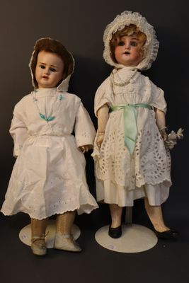 two dolls that are standing next to each other