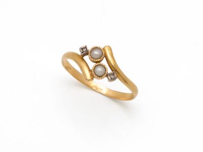 une image représentant une bague en or ornée de deux perles