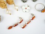 many different types of jewelry on a white surface