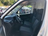 the interior of a white van with black seats and a steering wheel