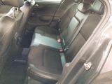 the back seats of a car with a cell phone in the passenger seat