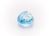 a close up of a blue diamond on a white surface