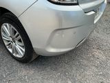 a silver car that is parked on the side of the road