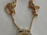 an image of a necklace with a picture of a woman on it