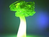 a green mushroom shaped light that is on a table