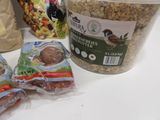 a bucket of granola and two bags of granola next to a bag of granola