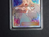 an image of a pokemon trading card with a picture of a woman holding a pokemon