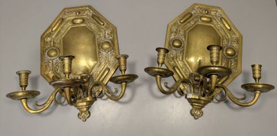 pair of antique brass wall sconces with sconces in the shape of a shield