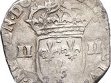 an old silver coin with a crown on top of it