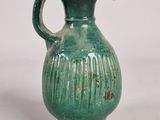 a green vase with a handle on a white background