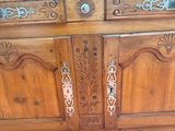 a wooden cabinet that has a mirror on top of it