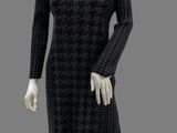 mannequin dressed in a black and white dress on a gray background