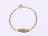 a gold bracelet with an engraved message on it