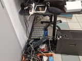 a computer desk with a lot of electronics on top of it