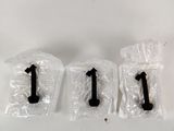 three plastic bags with numbers on them sitting on top of a table