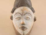 an image of a close up of a mask on a wall