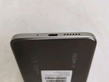 the back of a black cell phone with a white sticker on it